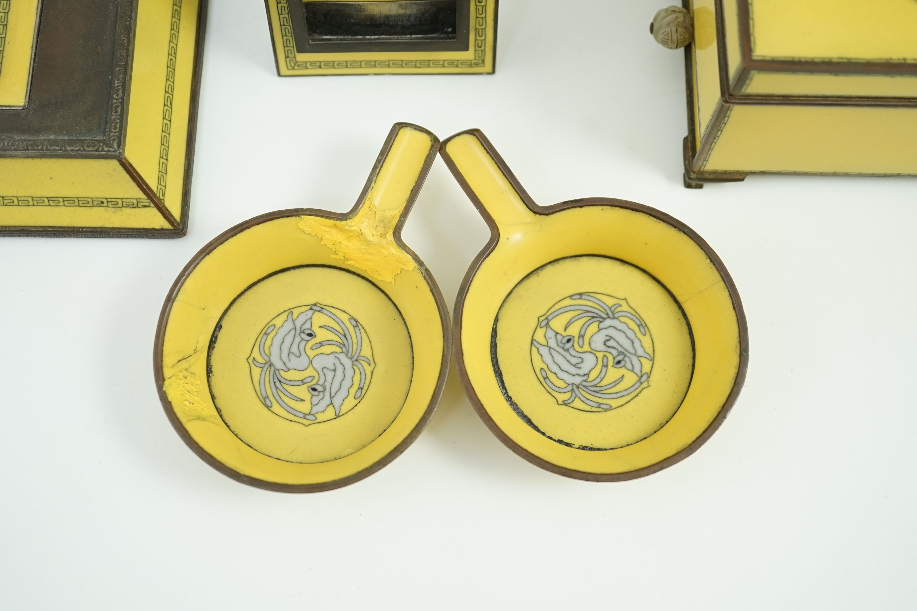 A Japanese cloisonné enamel desk set, 1920s, mounted with two Chinese Qing dynasty pale celadon jade plaques, retailed by Yamanaka & Co., Inkstand 31cm wide